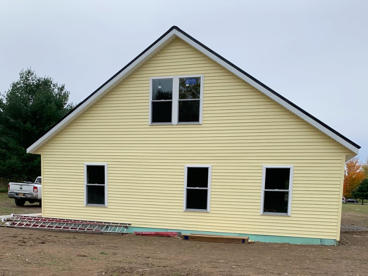 big yellow barn with new sidings