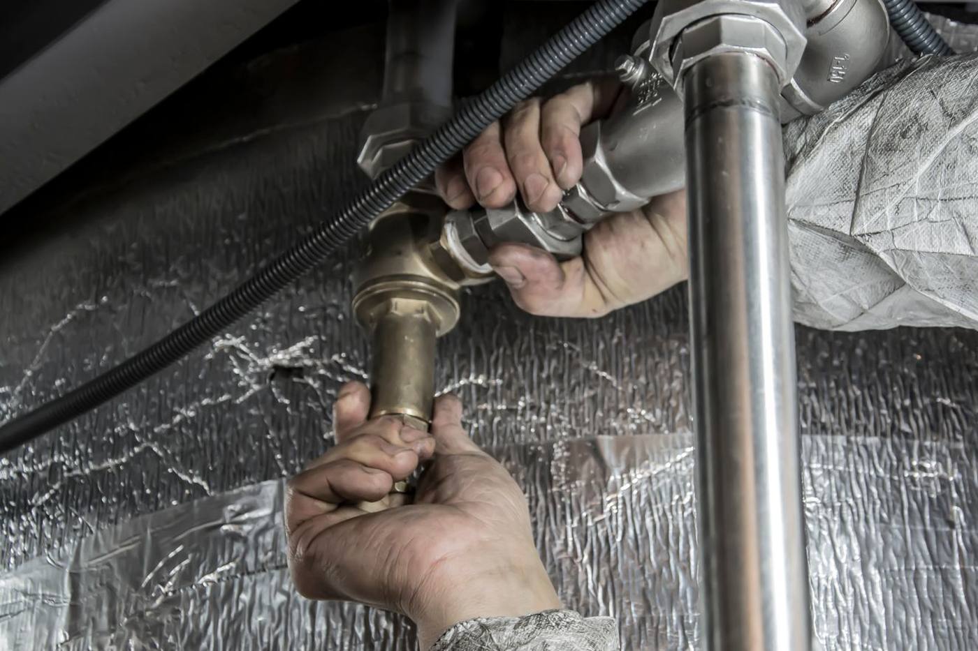 Plumber fitting a pipe