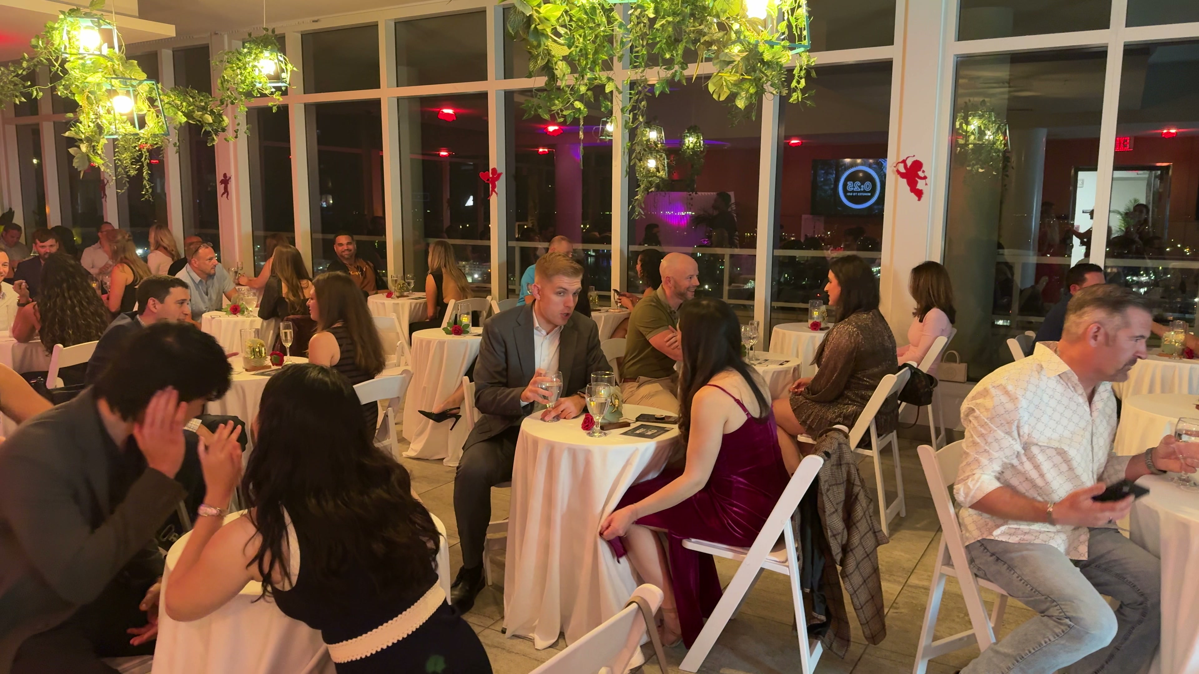 Full room wide shot — packed premium venue with couples at tables