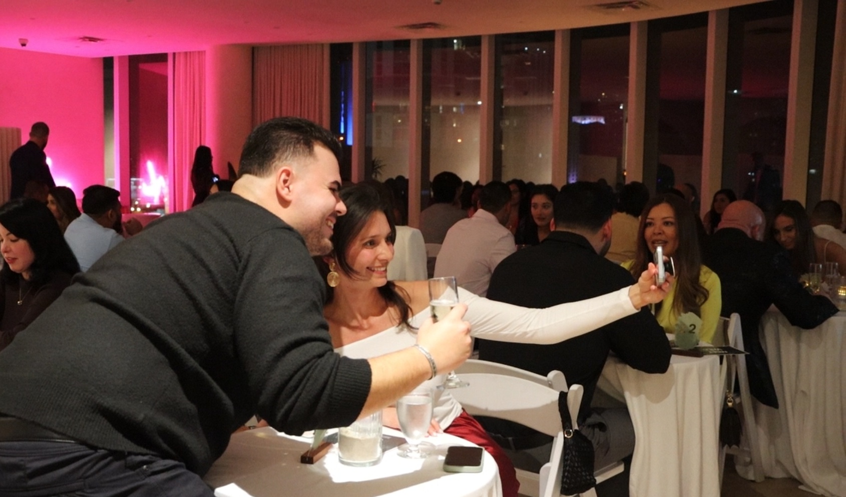 Couple taking a selfie together at a MITW event — connection moment