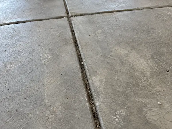 Straight saw-cut control joints crossing a concrete garage floor