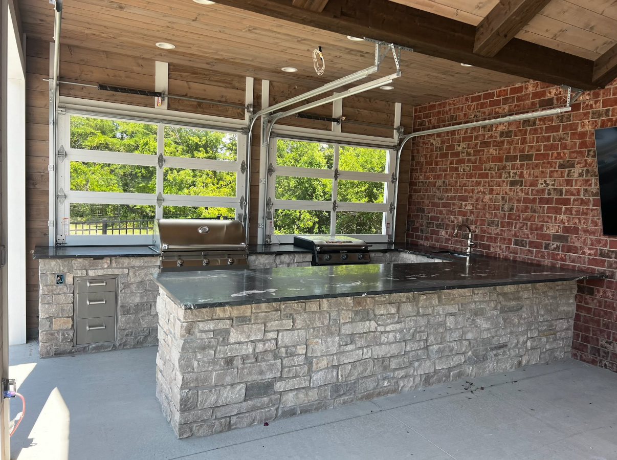 A unique, one-of-a-kind custom outdoor grill area designed to fit perfectly into the existing landscape