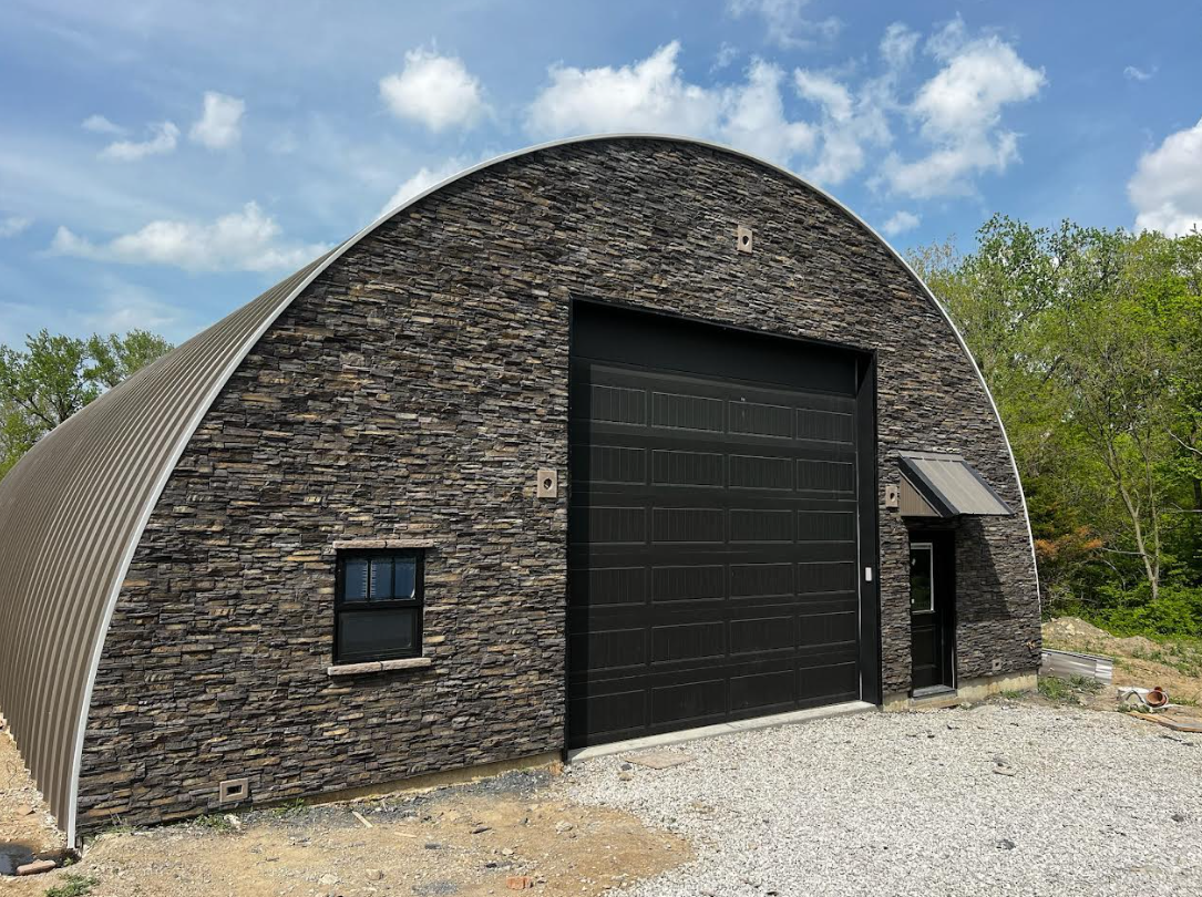 A modern home exterior featuring a striking stone façade and architectural details