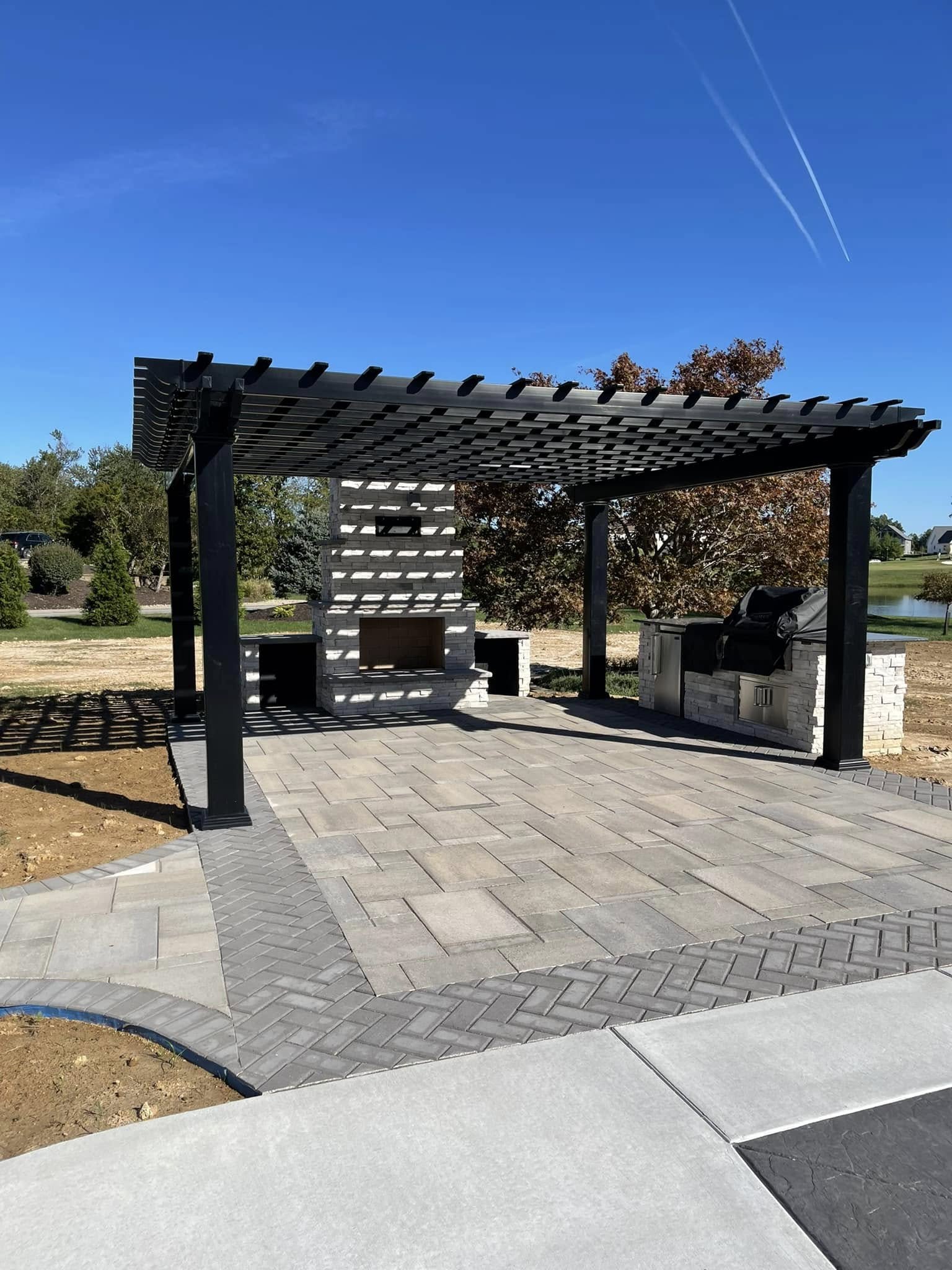 Custom outdoor living area featuring a heavy-duty wood pergola over a seating space