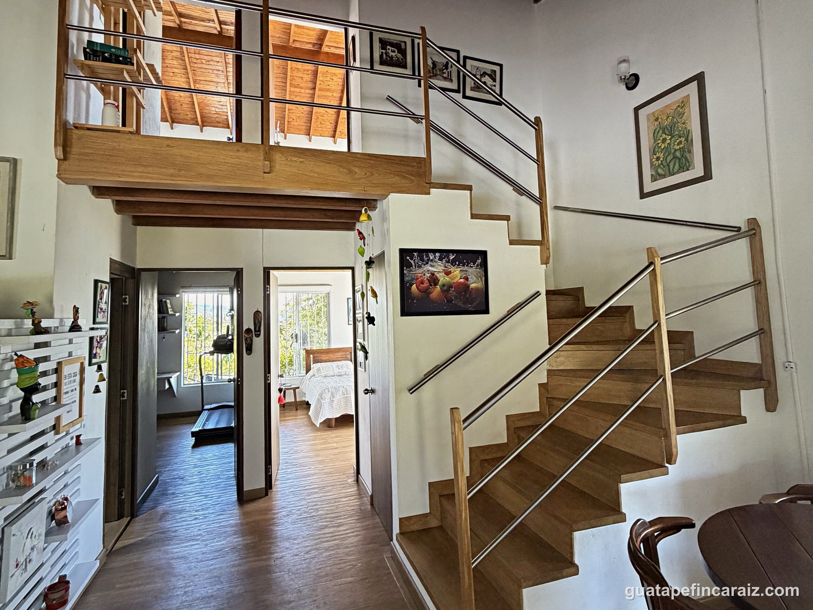Wood and stainless-steel staircase leading to the loft level
