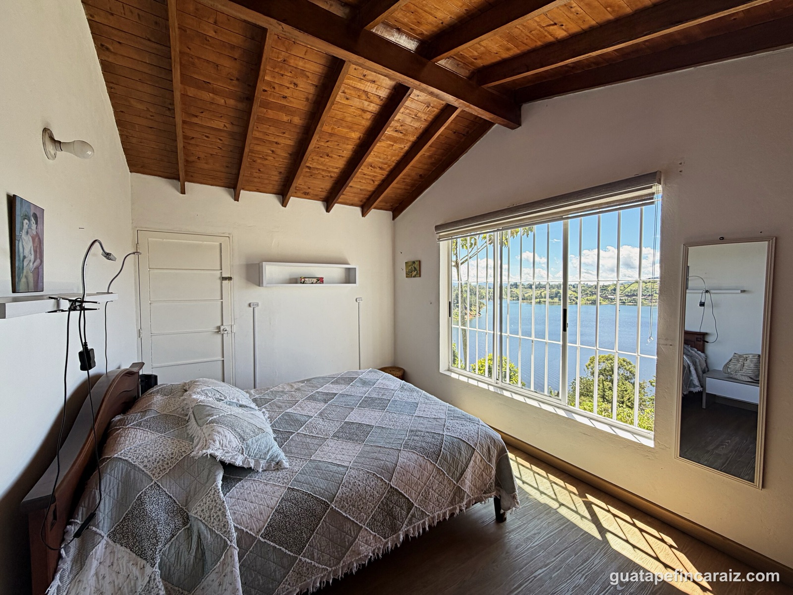 Bedroom with lake view and mirrored wall