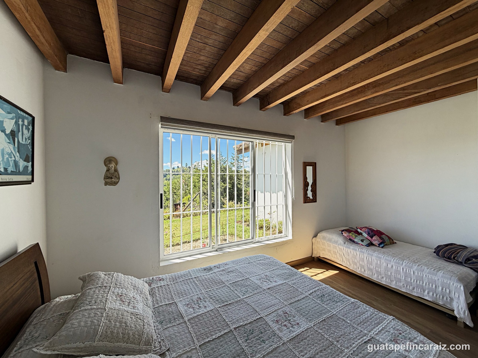 Bedroom with twin and queen beds, ideal for family stays