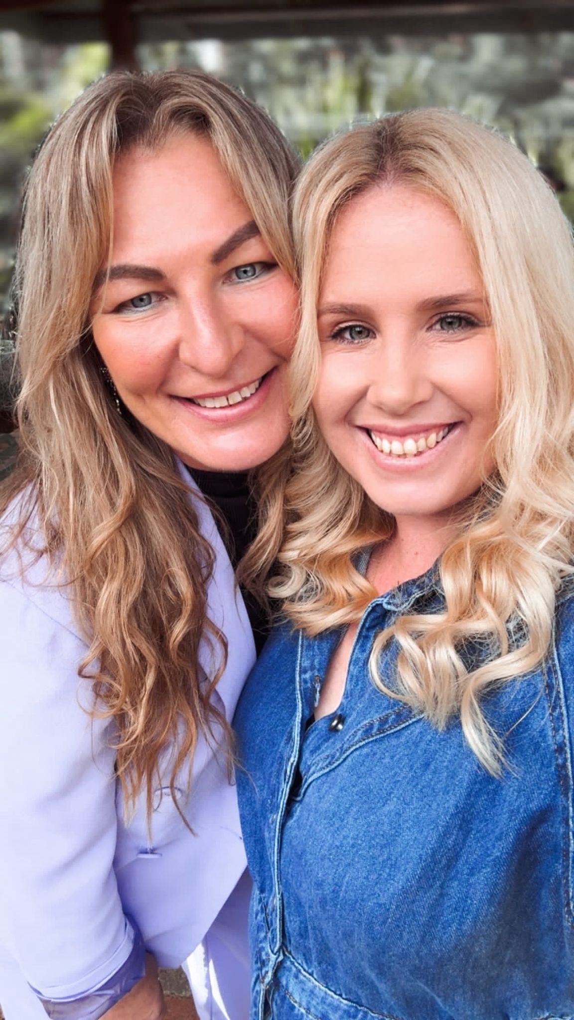 Two members of the DVINE team smiling together