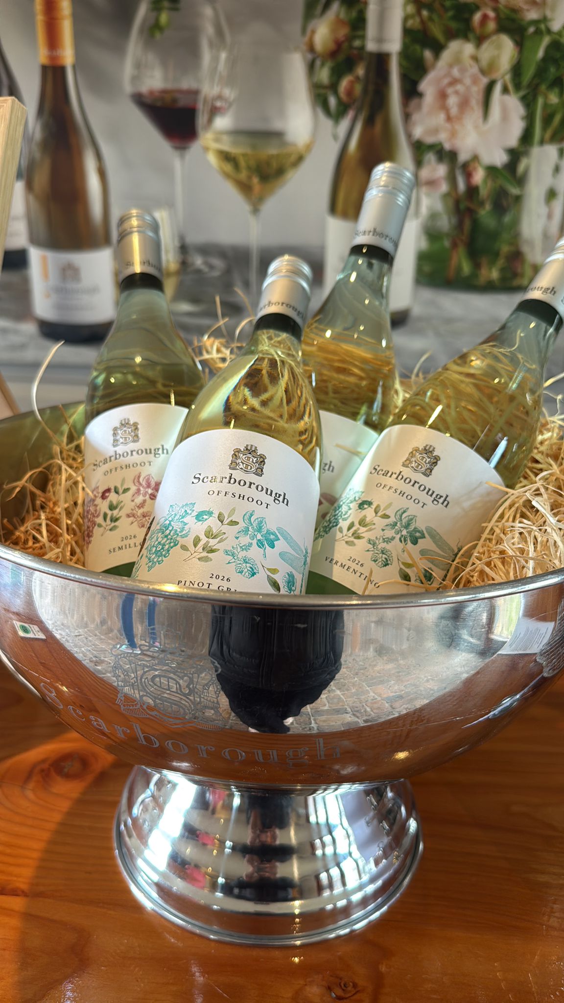 Bottles of white wine chilling in a silver ice bucket at a cellar door tasting