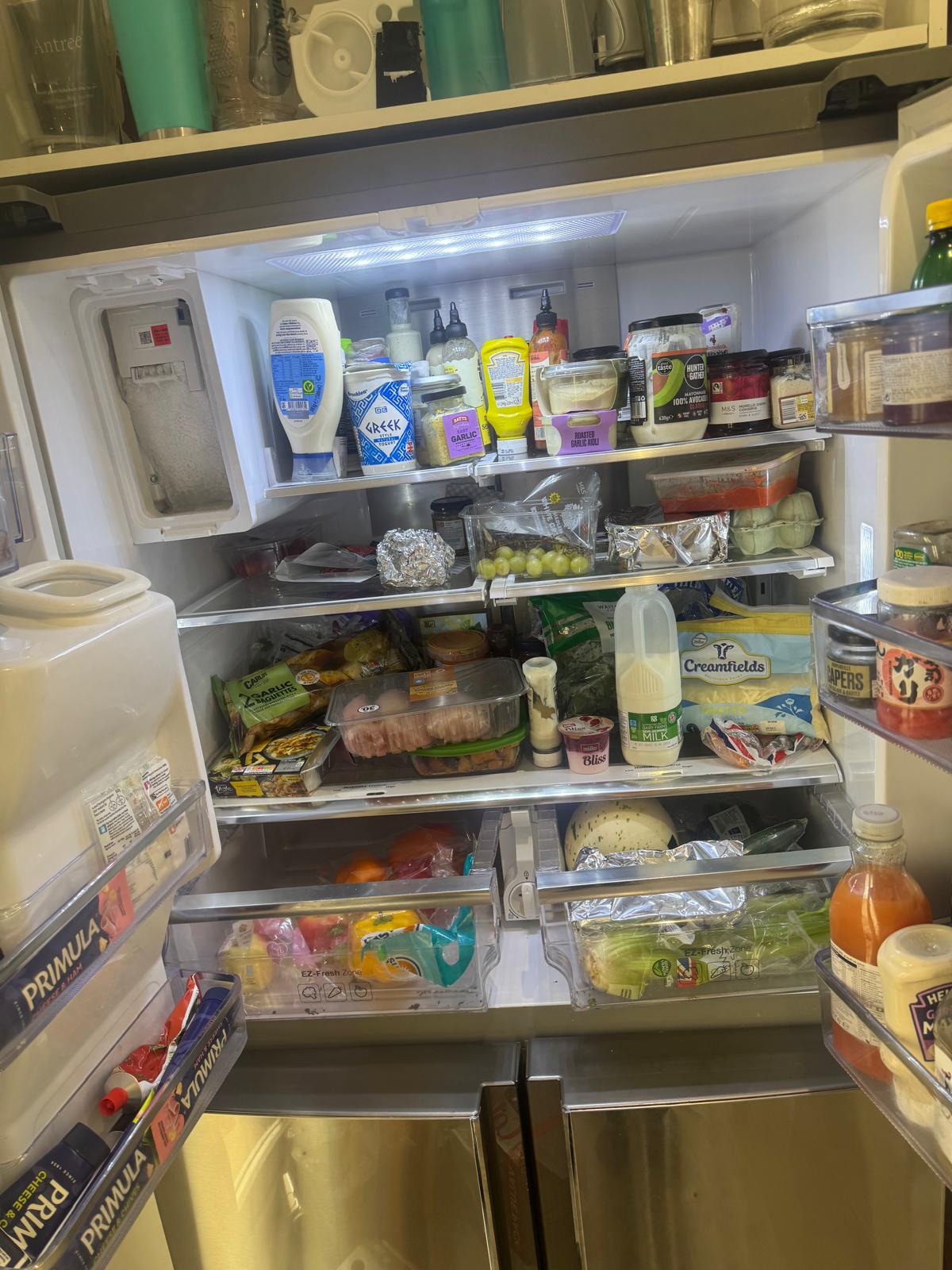 The inside of a well stocked fridge, with sauces and condiments on the top shelf, packets and leftovers in the middle, and vegetables in the drawers below. The inside of a well stocked fridge, with sauces and condiments on the top shelf, packets and leftovers in the middle, and vegetables in the drawers below.