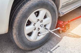 Woman talking on phone waiting for roadside assistance
