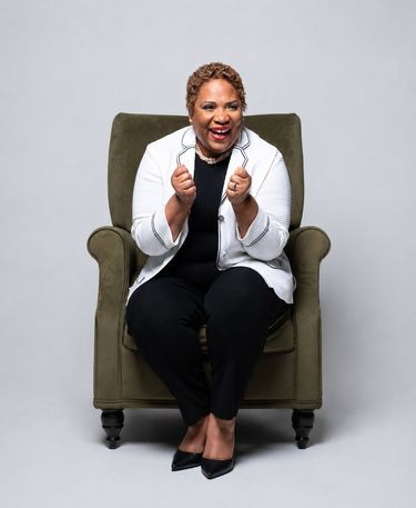 Elaine Robinson Beattie smiling, seated in an armchair