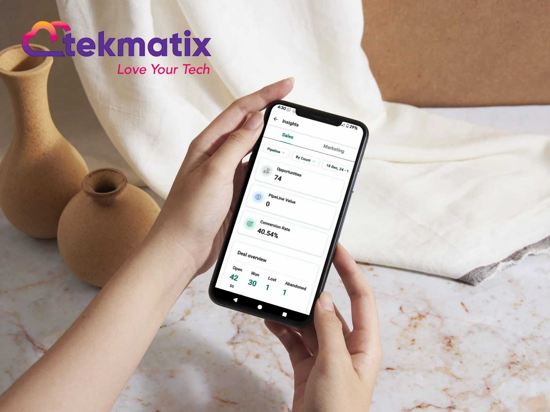 Photo of someone holding a phone with tekmatix app showing Photo of someone holding a phone with tekmatix app showing