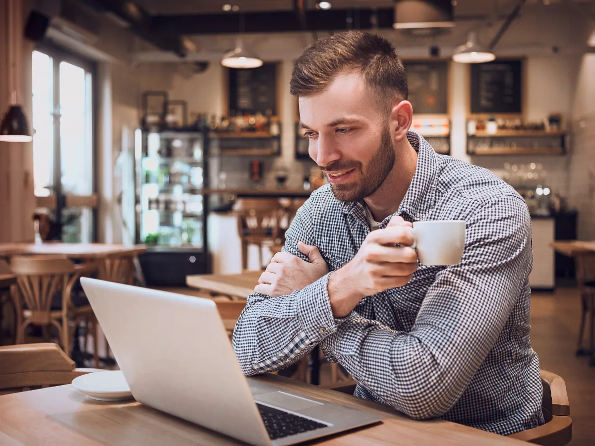 Local person searching for nearby allied health services on a laptop in a café, illustrating the importance of location-focused content