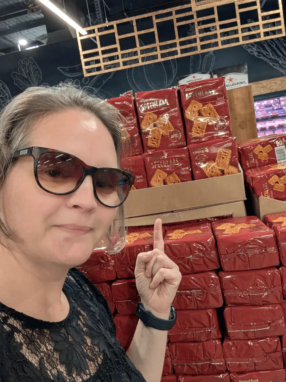 Ellie pointing to Dutch Christmas biscuits on sale in a shop