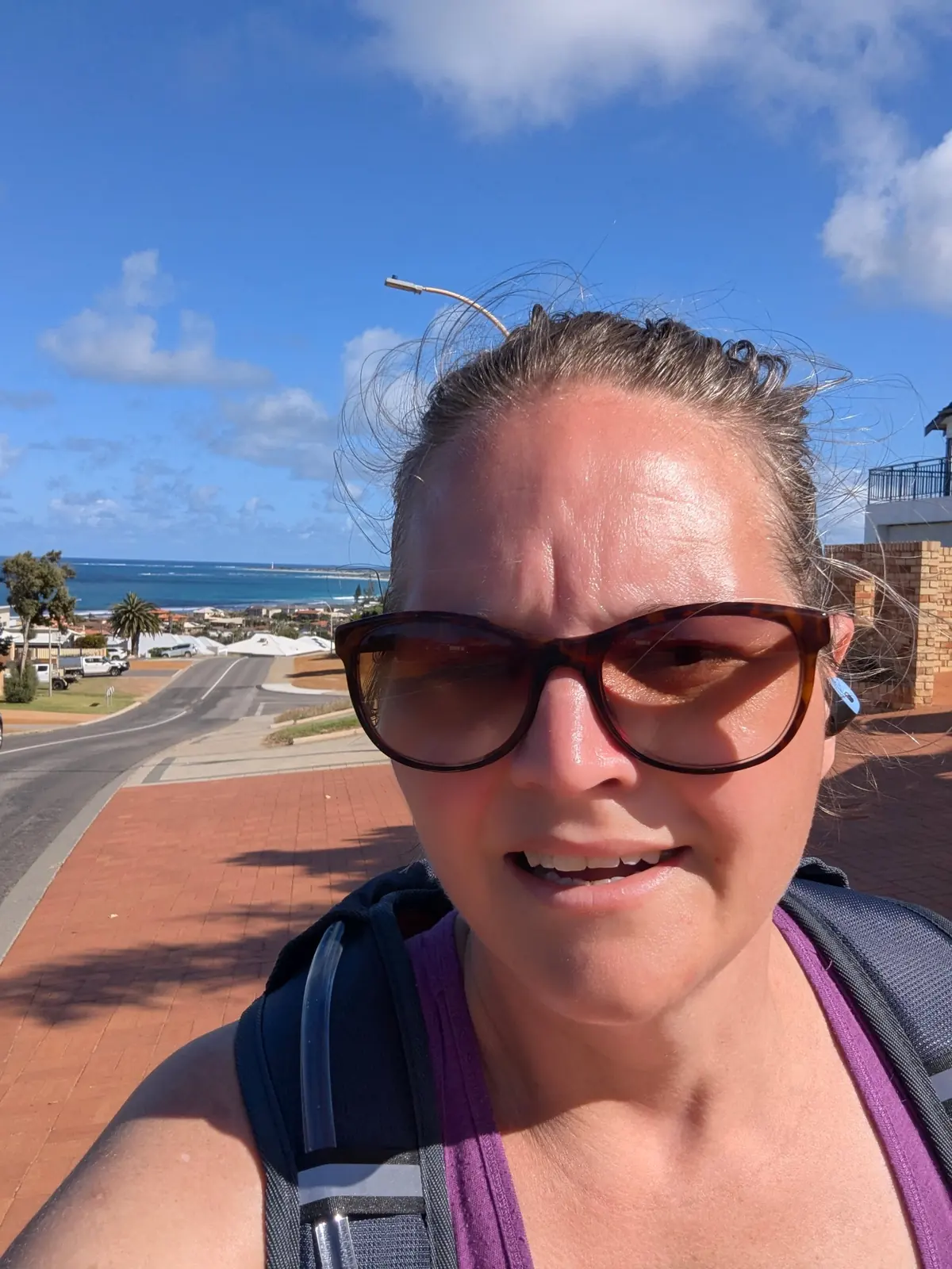Ellie Clare on a windy coastal walk in Geraldton with the ocean behind her Ellie Clare on a windy coastal walk in Geraldton with the ocean behind her