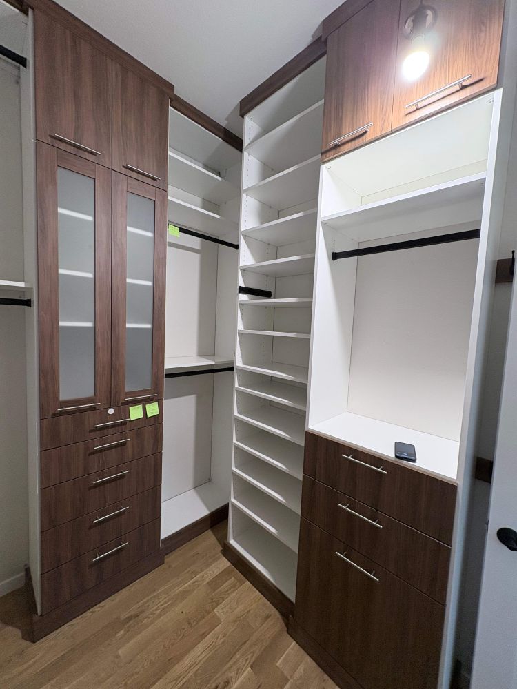 two tone walk-in closet with integrated lighting in Lafayette Colorado