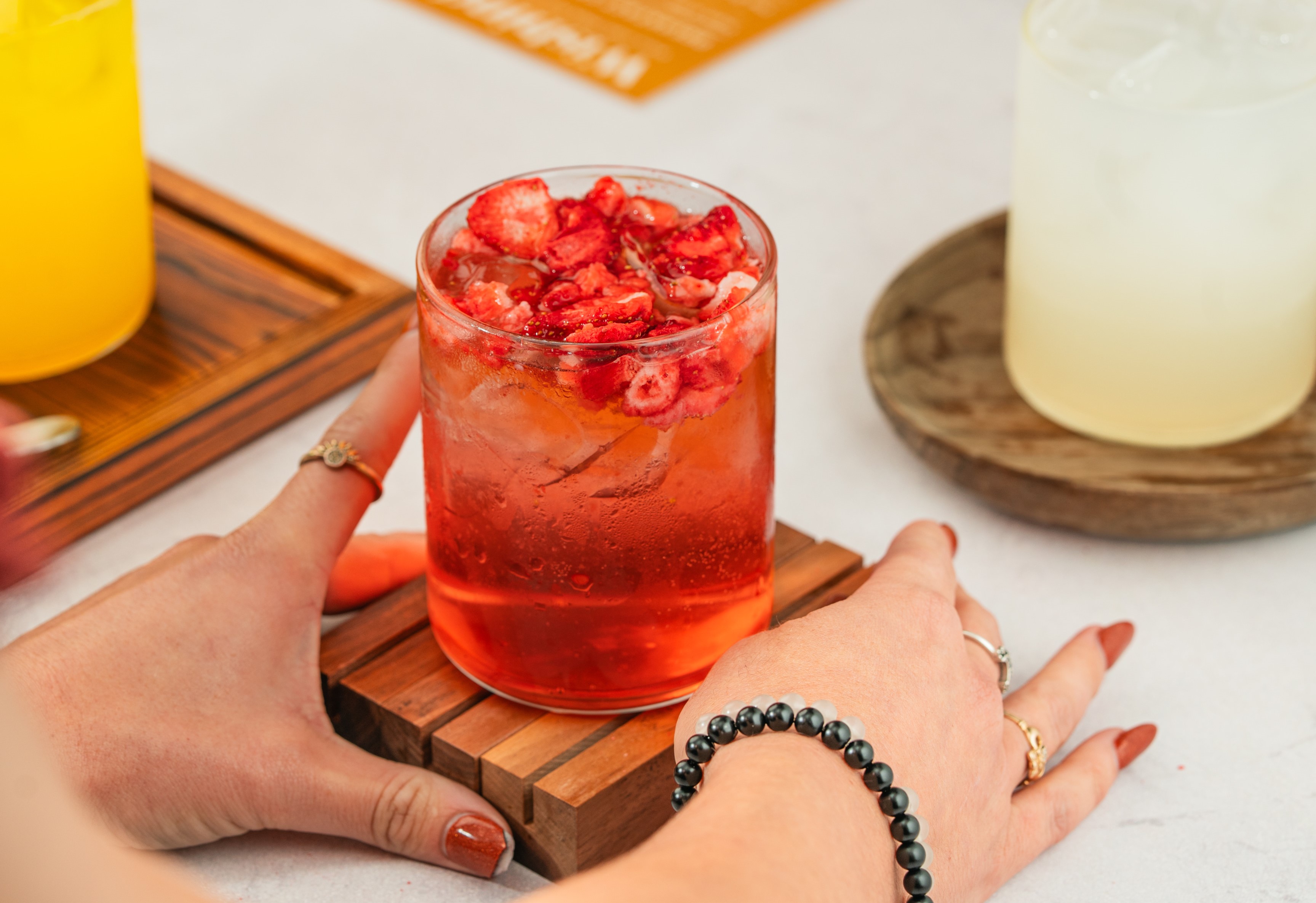 Hands holding a fruity refresher