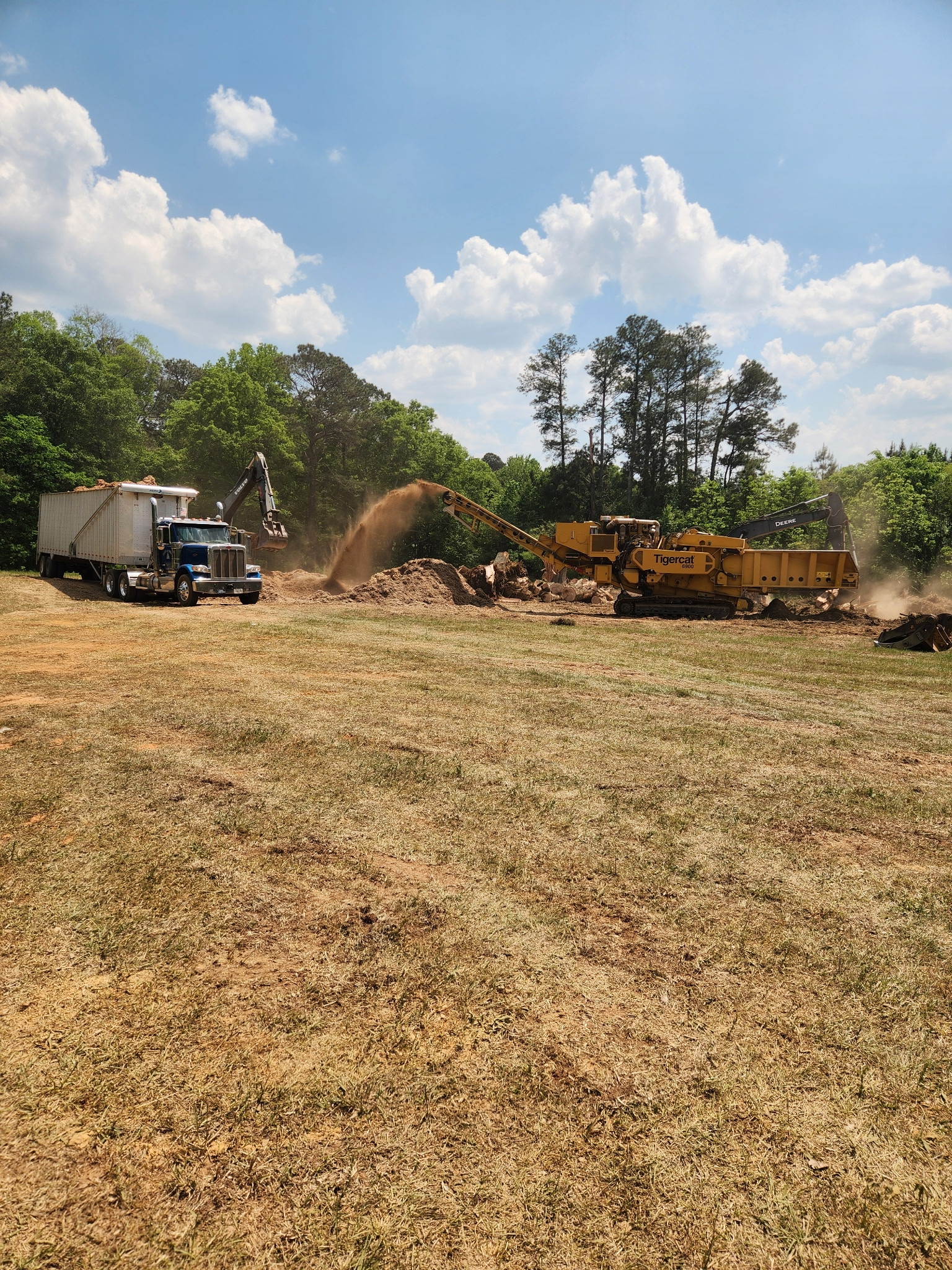 Horizontal grinder processing land-clearing debris