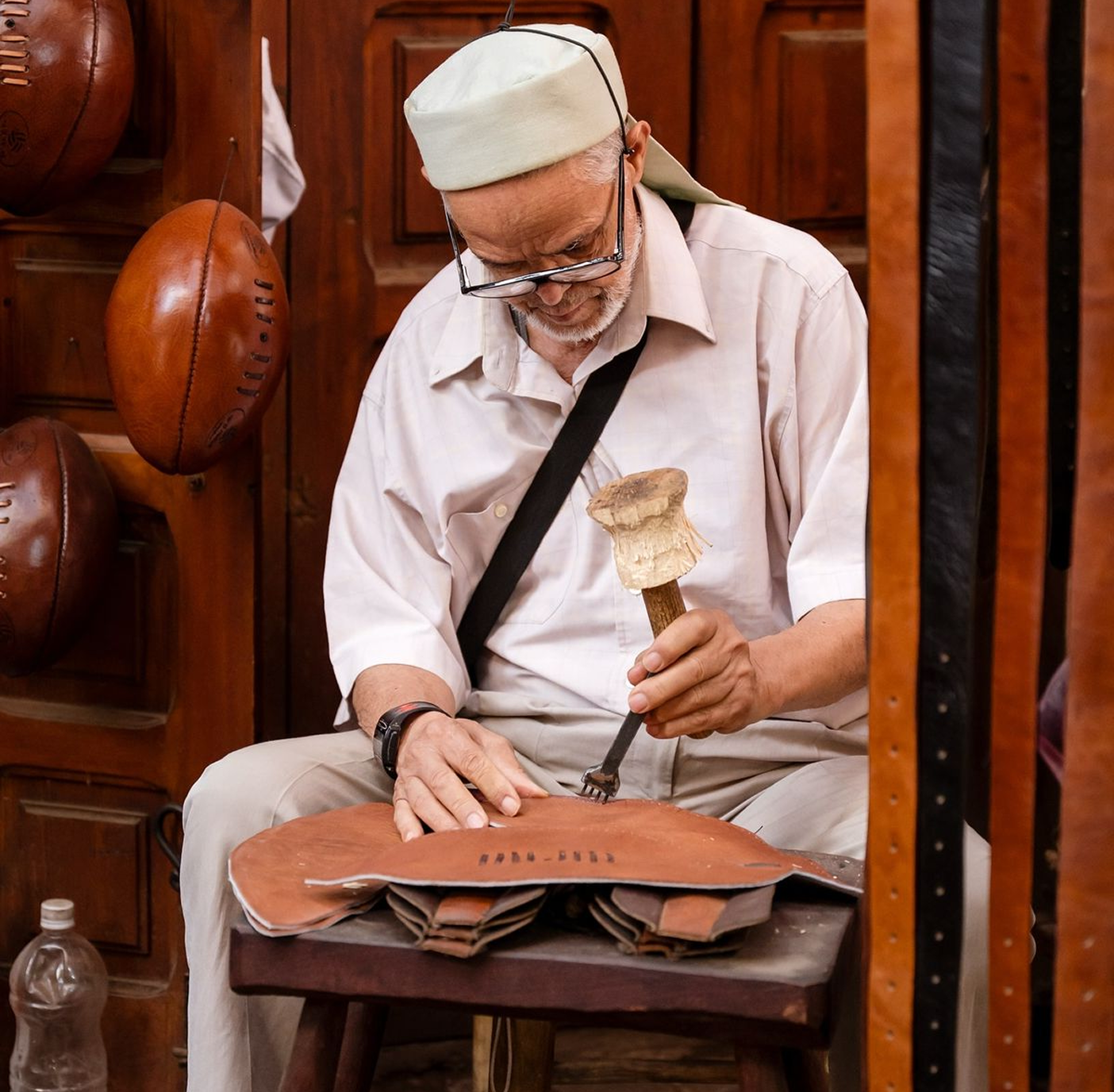 Moroccan artisan crafting leather