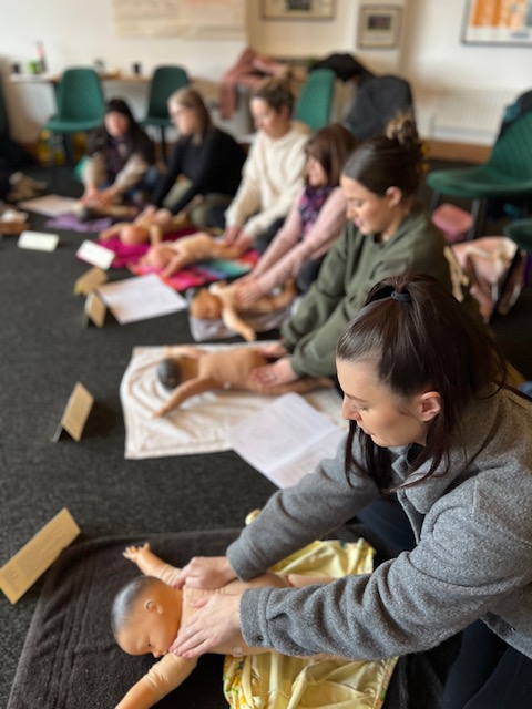 delegates practicing massage on dolls