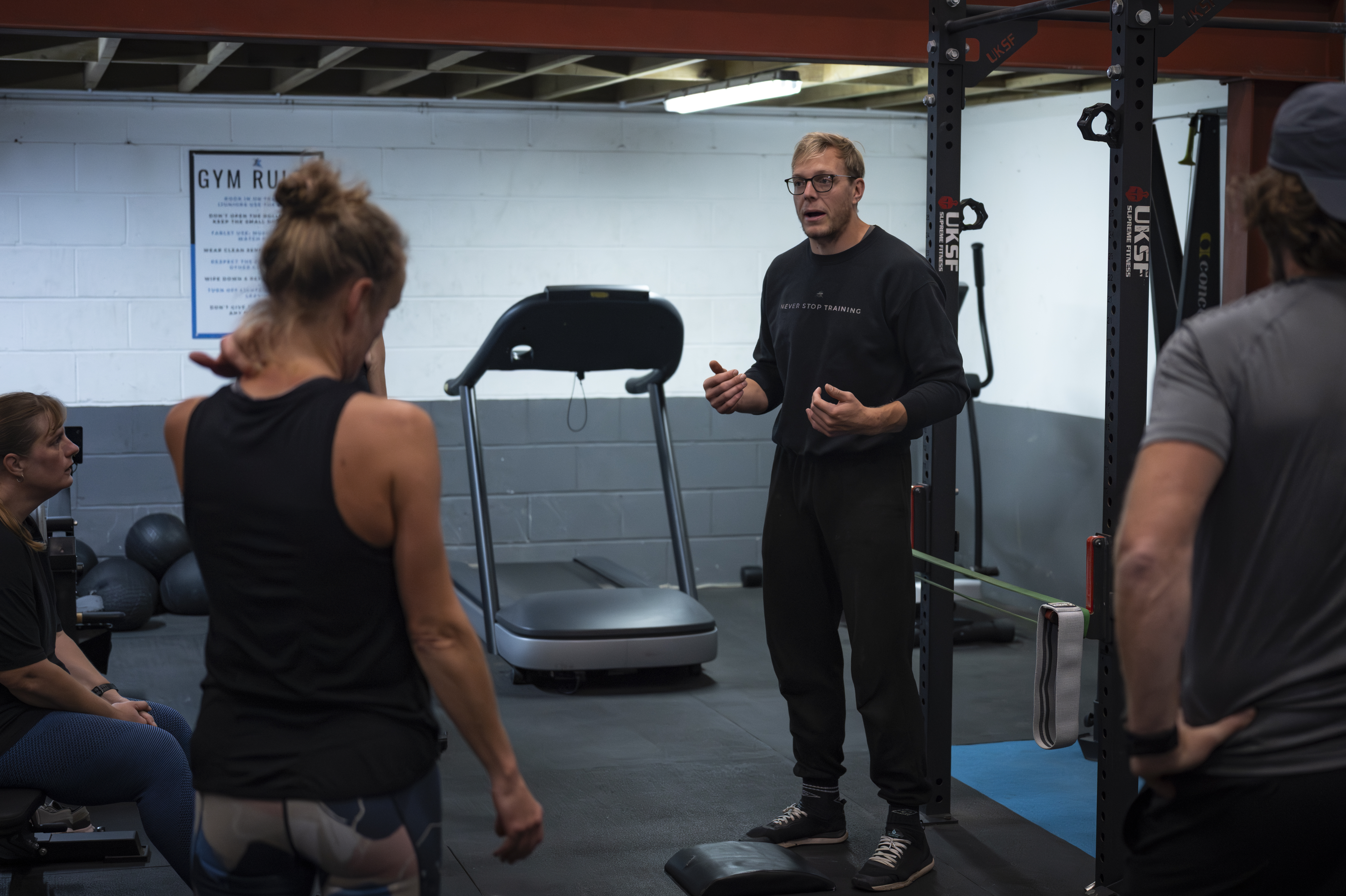 Older adult practicing a controlled hip hinge with guidance from a coach