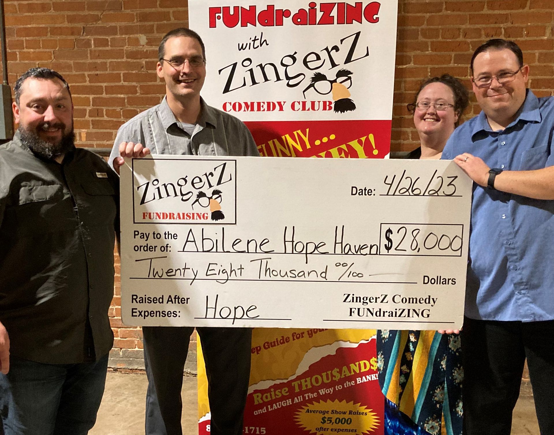 Organizers holding a $28,000 ZingerZ FUNdraising check for Abilene Hope Haven