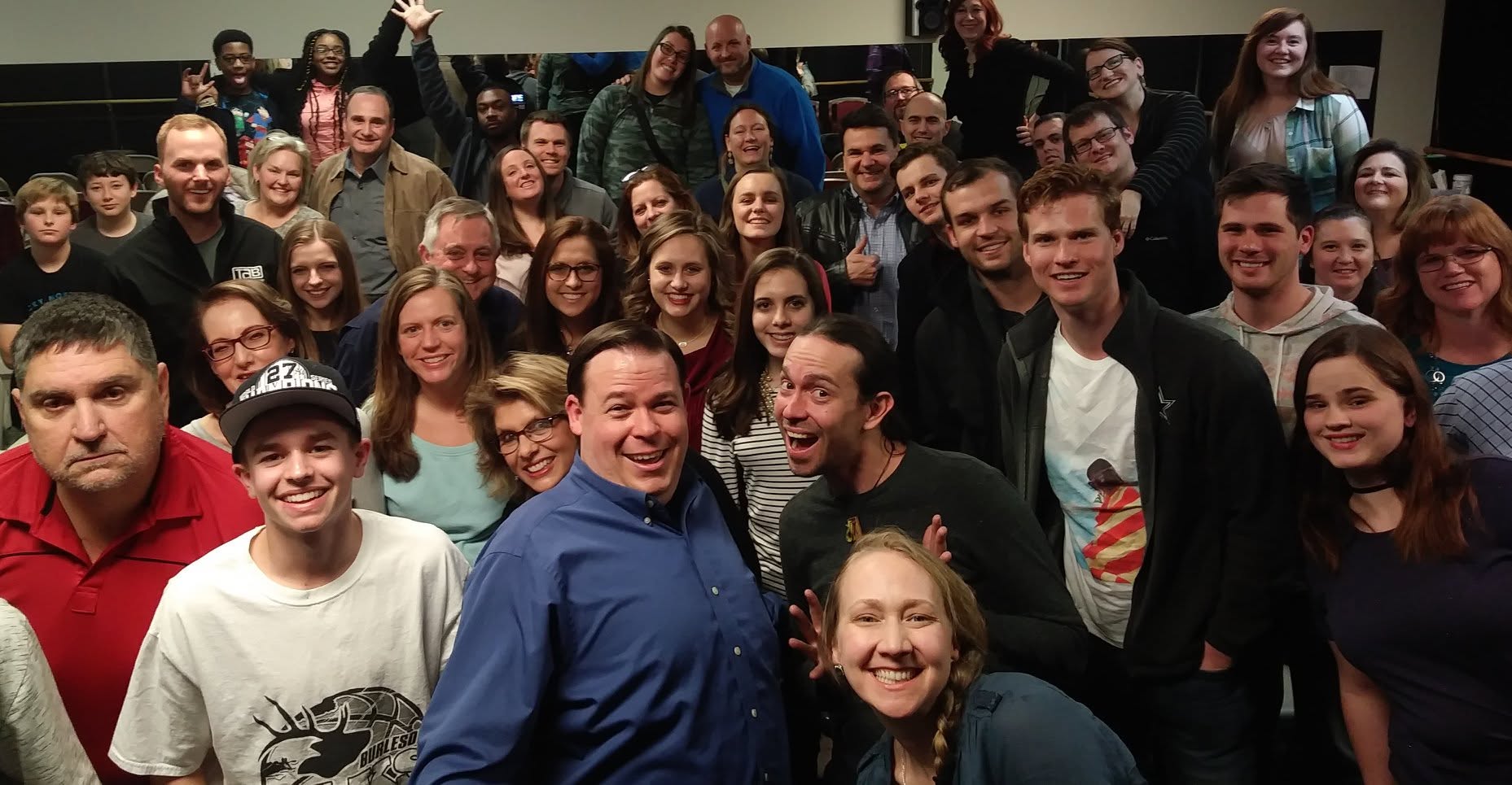 A packed crowd of guests posing together after the show