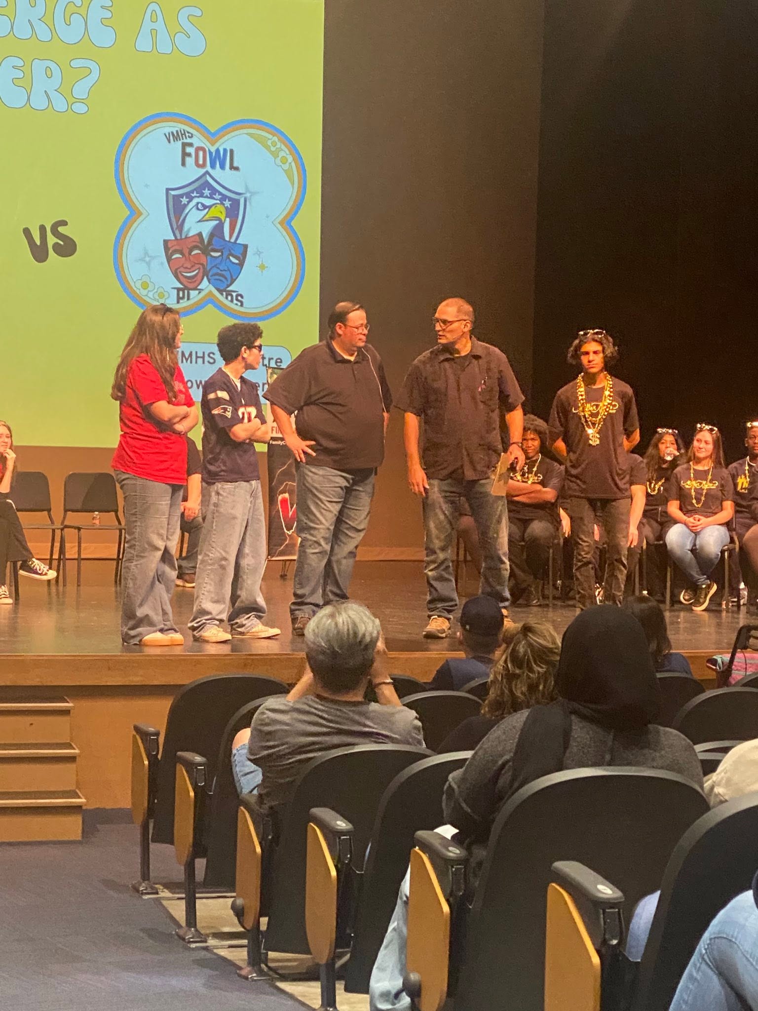 Performers mid-scene onstage during an Improv Battle round