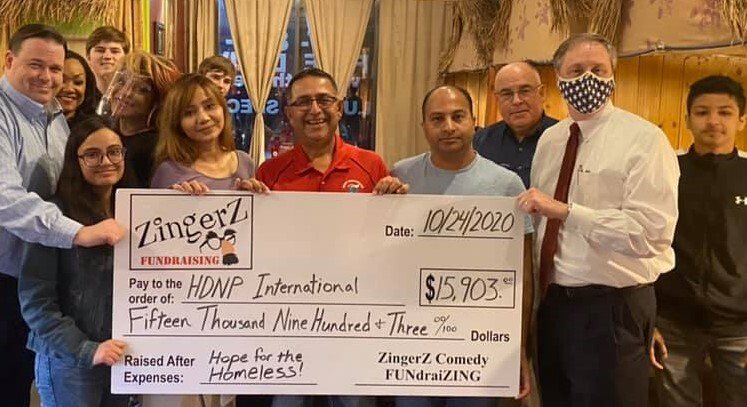 Group holding a ZingerZ big check for $15,903 raised for Hope for the Homeless