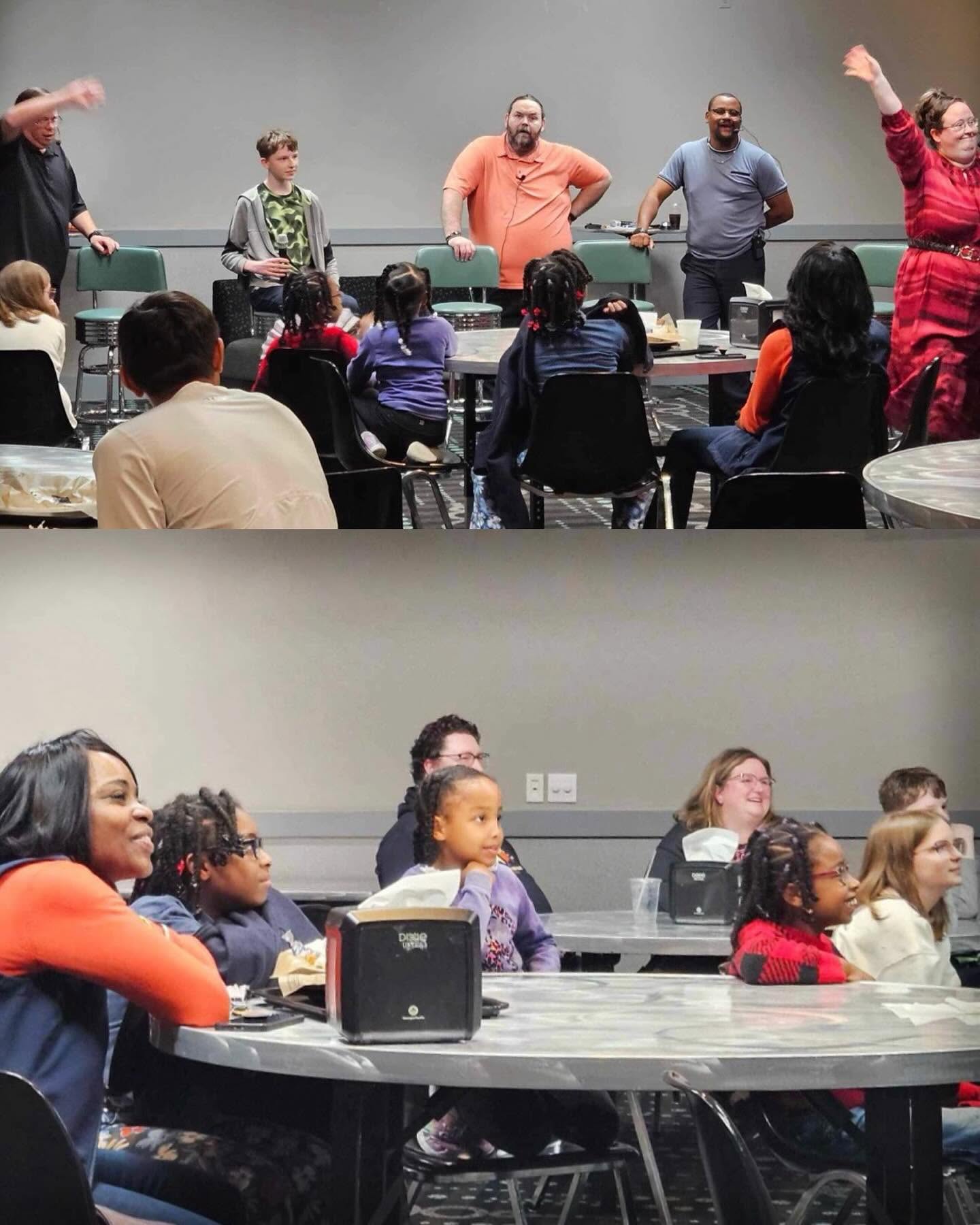 Guests seated at tables laughing during an interactive play fundraiser
