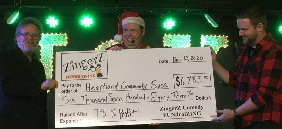 Handing over a $6,783 ZingerZ big check to Heartland Community Services
