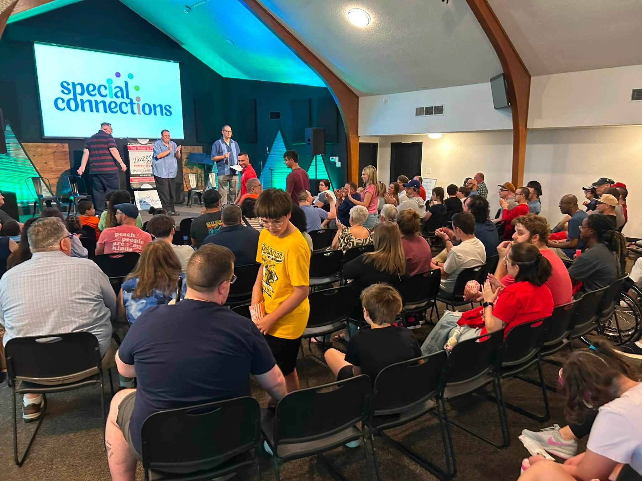 A packed room watching the ZingerZ cast on stage at a Special Connections fundraiser