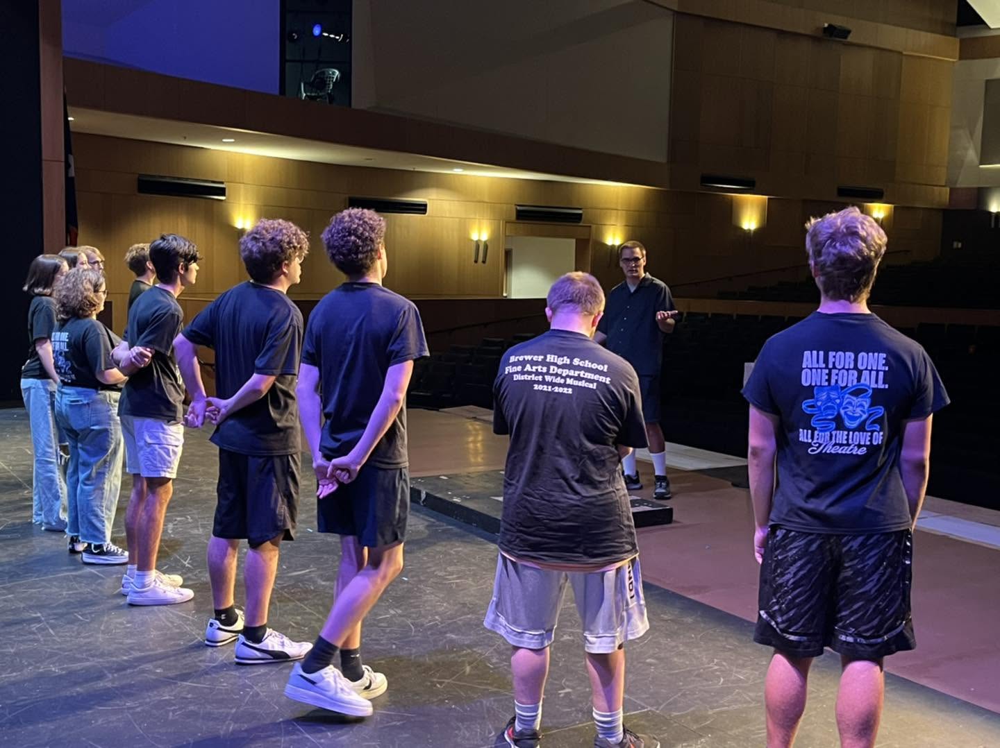 Students lined up on stage during an improv workshop