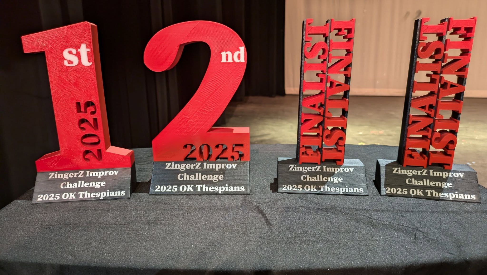 ZingerZ Improv Challenge trophies on a table