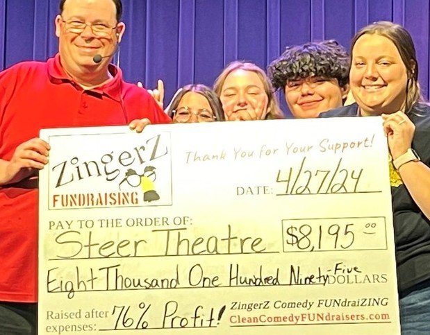 Steer Theatre students holding a ZingerZ big check for $8,195 raised, 76% profit