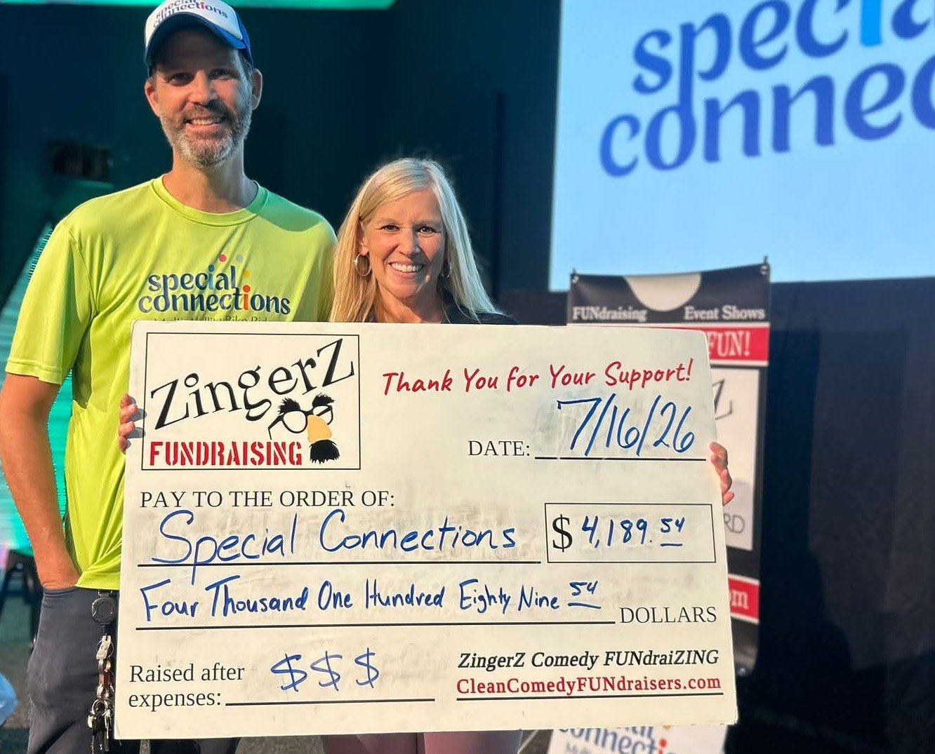 Special Connections team holding a ZingerZ big check for $4,189.54 raised