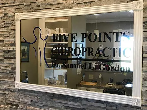 Five Points Chiropractic Dr. Samuel L. Gordon sign on the office mirror