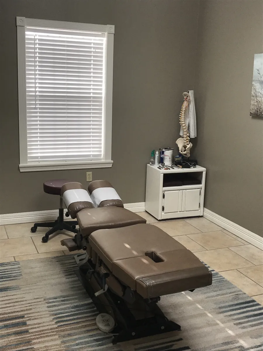 Cox table and spine model in a Five Points Chiropractic treatment room