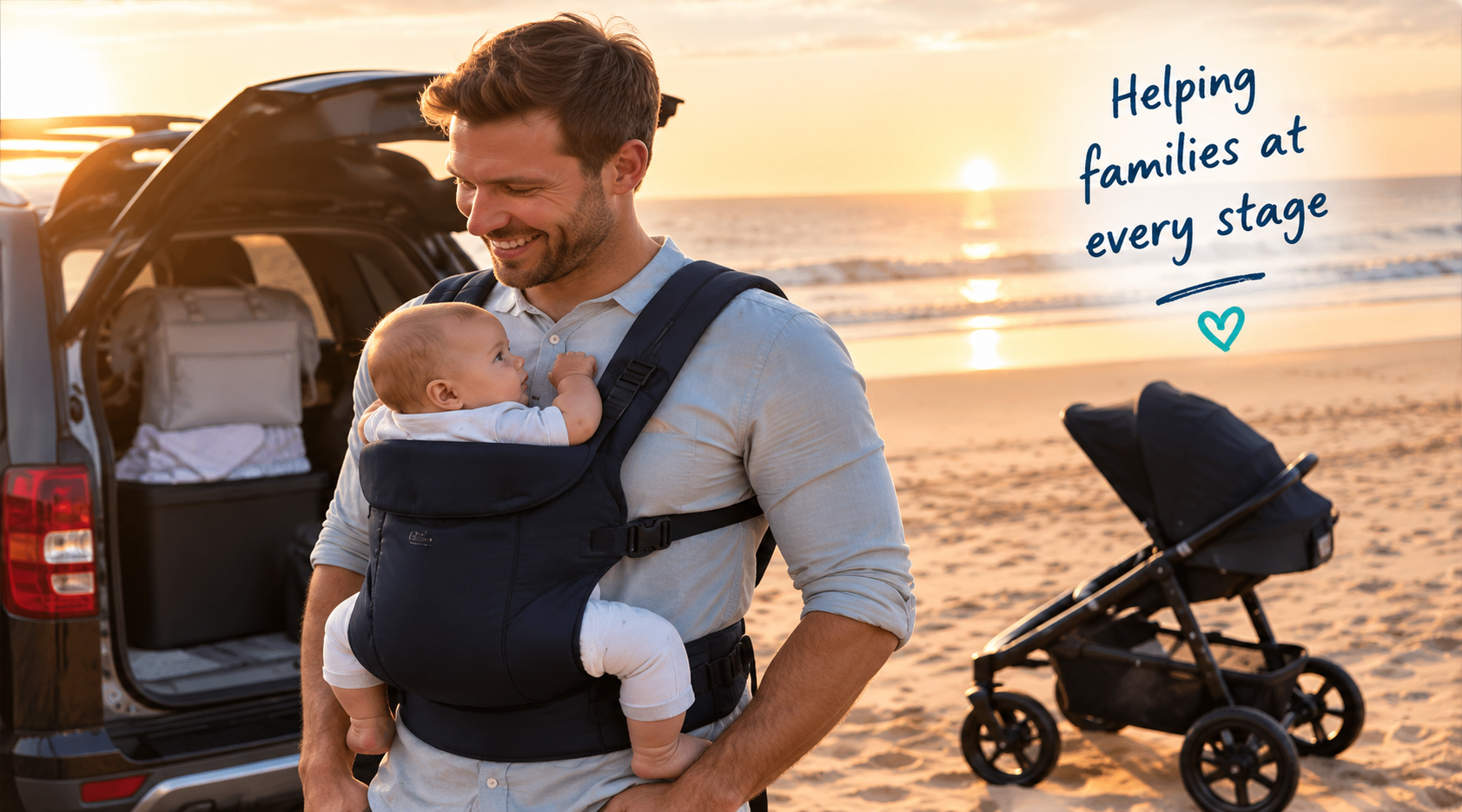 Dad with baby carrier and pram at the beach