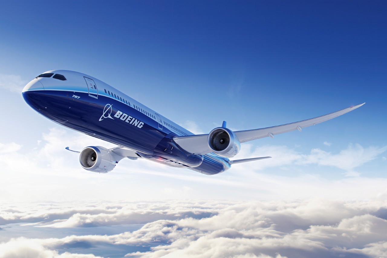 Boeing 787 in flight above the clouds