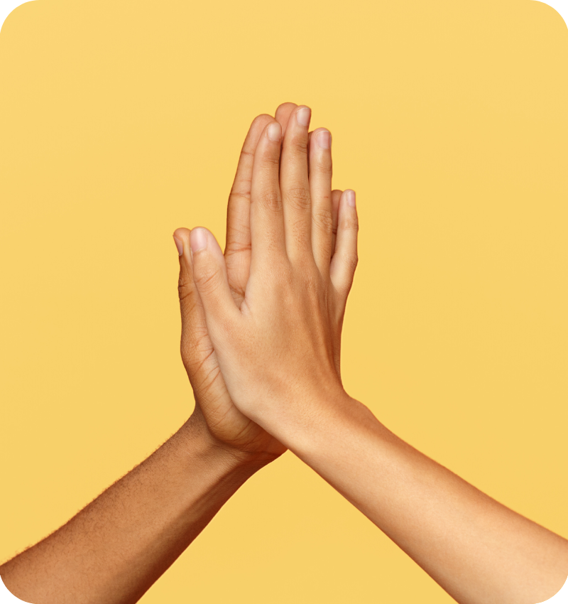 Two hands high-fiving against a yellow background, symbolising collaboration, partnership, and Teljay Marketing’s friendly, supportive client approach.