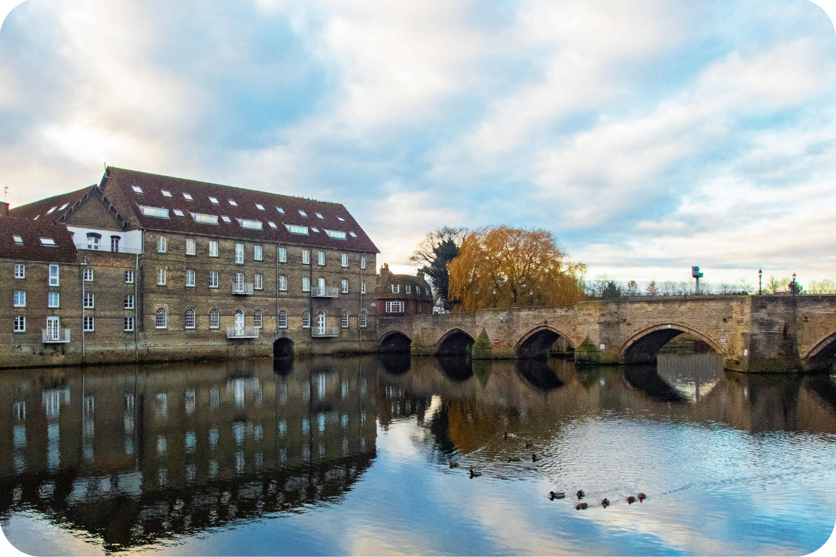 Scenic view of a historic bridge and river in Huntingdonshire, highlighting Teljay Marketing’s commitment to supporting local businesses in the community.