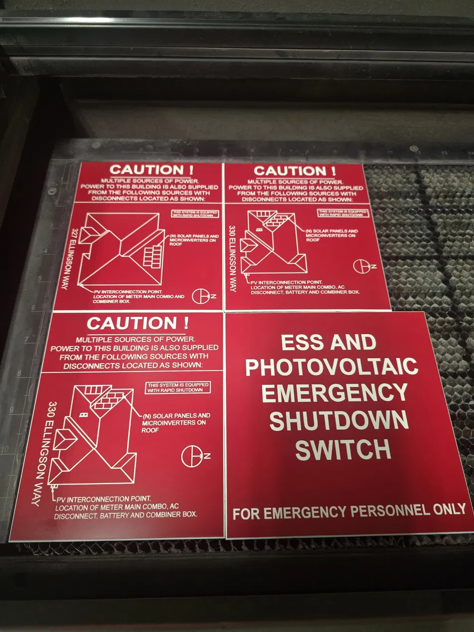 Engraved solar rapid shutdown compliance placards on Recognition Products laser bed — NEC 690.12(D) format