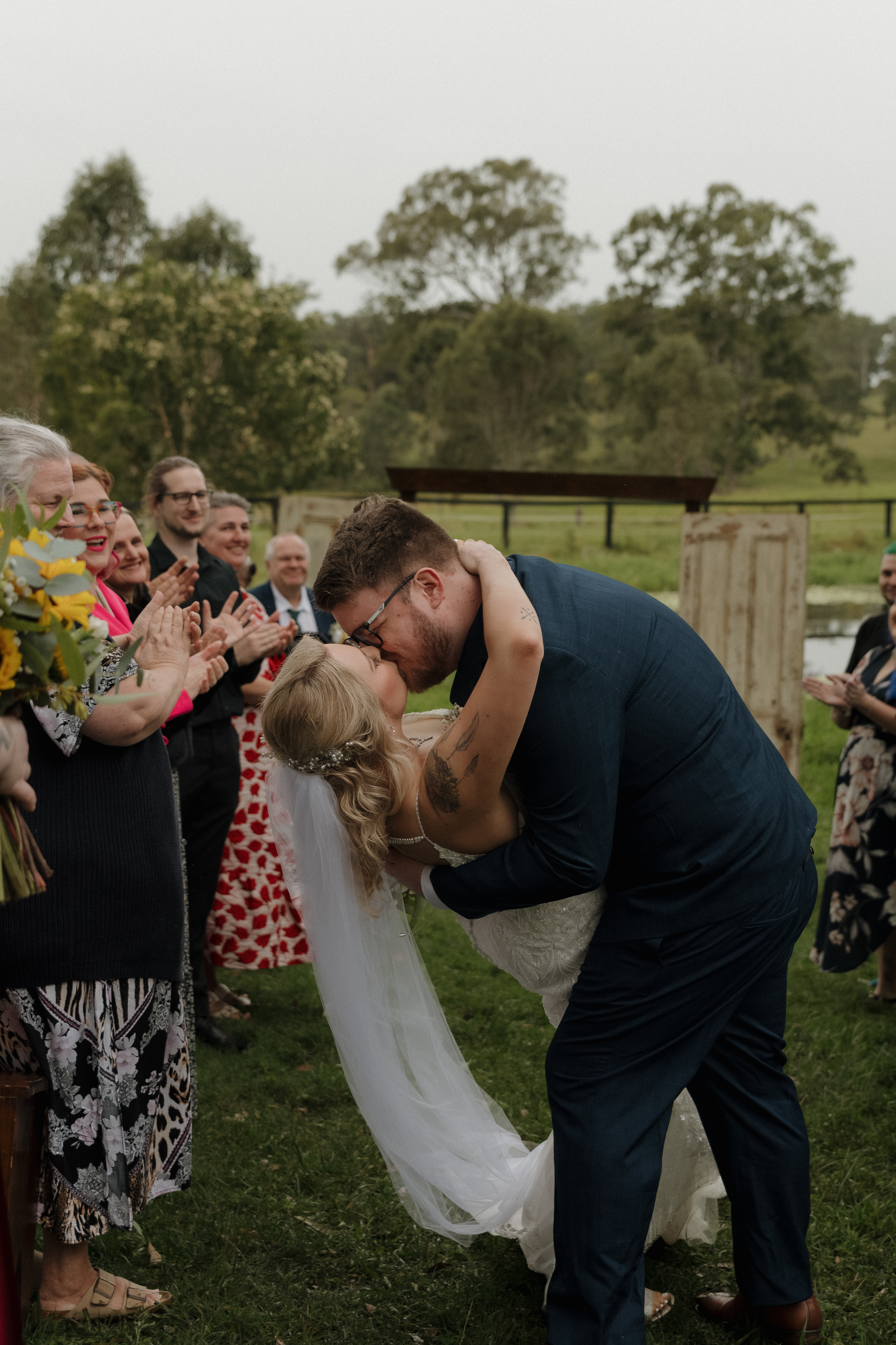 Wedding couple with umbrella in the rain