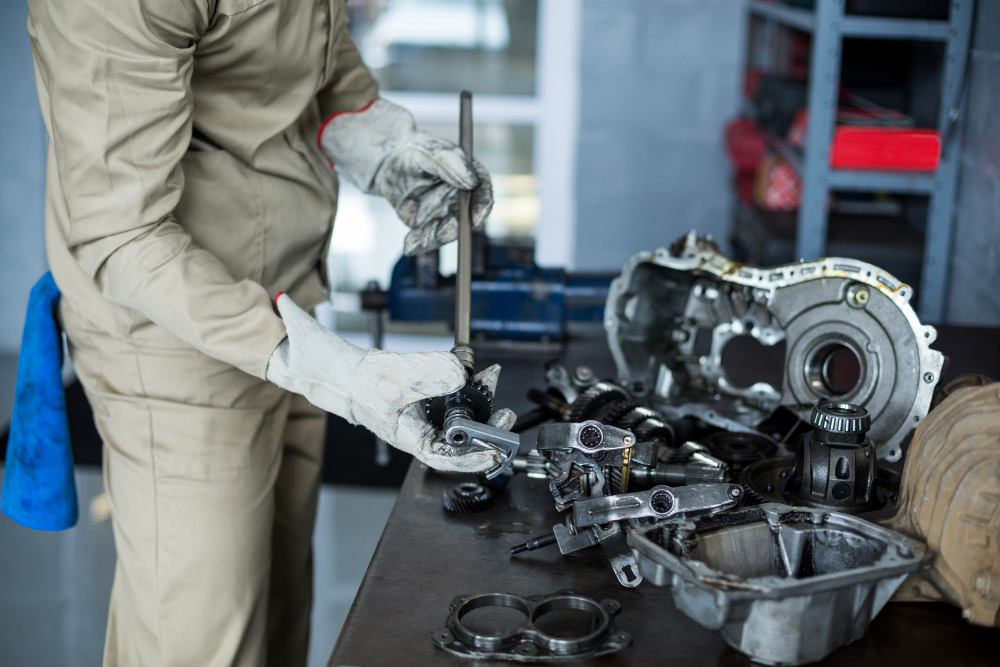 Mechanic performing engine repair on a vehicle at Ernie's Automotive Service