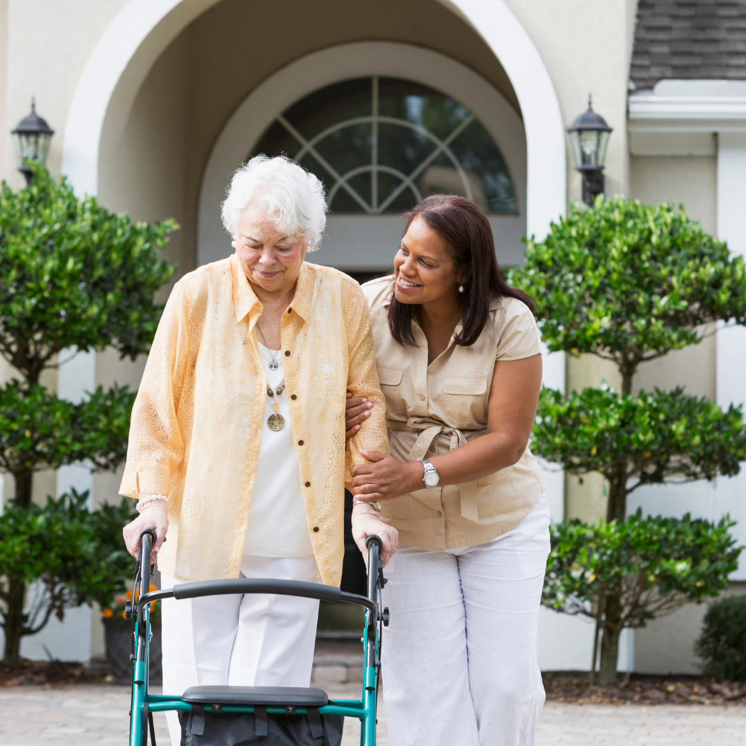 Woman helping older adult with walker