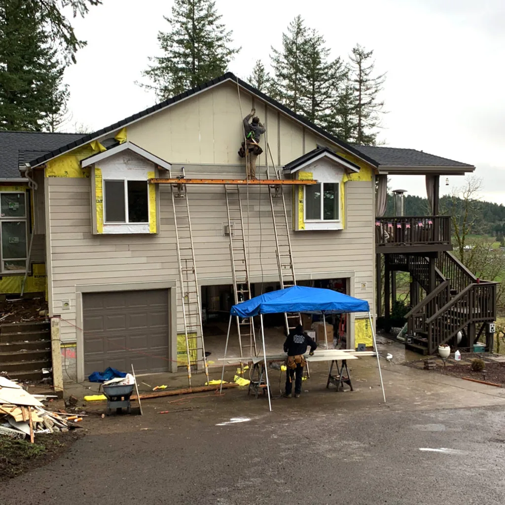 Before photo — Salem Oregon home mid-install with exposed siding areas and incomplete exterior finishes