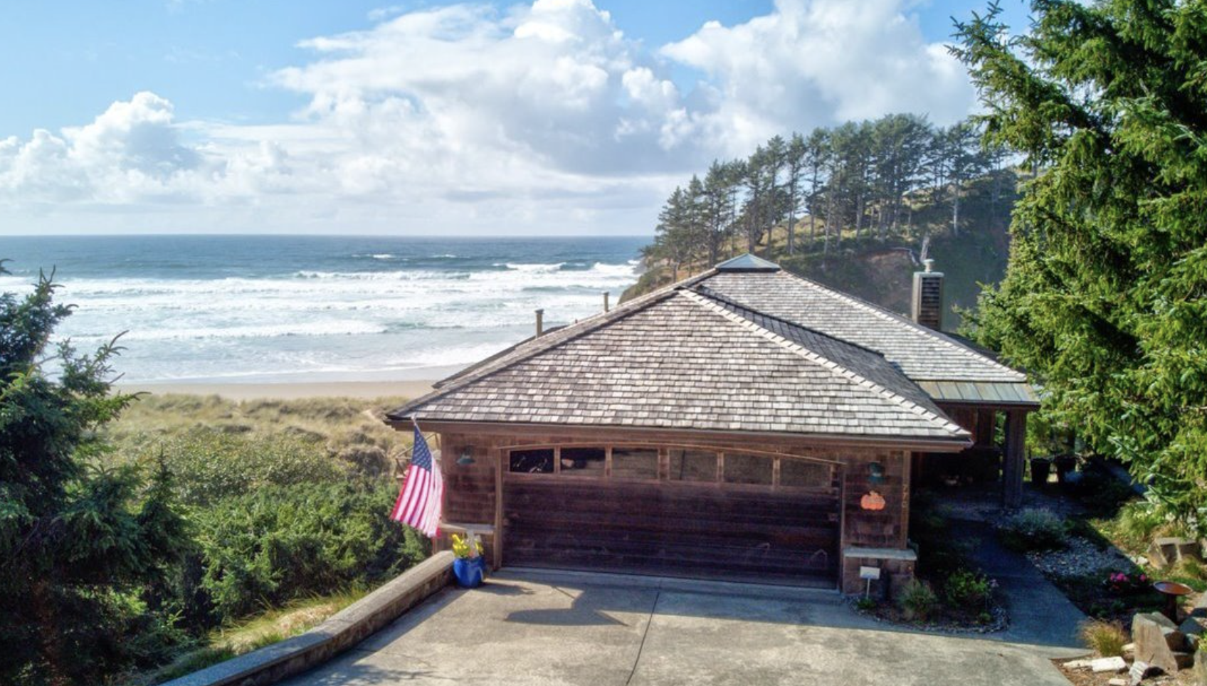 Beachfront Cannon Beach home with aged cedar shake roof showing moss and salt-air weathering before restoration
