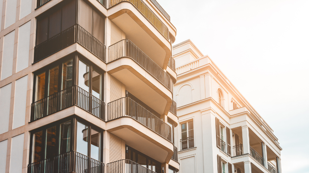A modern commercial multifamily building showcasing contemporary architecture, balconies, and upscale residential design, representing high-quality income-producing real estate. The image symbolizes commercial real estate investing, multifamily properties, apartment communities, passive real estate investing, property acquisition, portfolio diversification, long-term wealth creation, rental income, institutional-quality assets, market appreciation, and a complete guide to commercial real estate investing in Albany NY. A modern commercial multifamily building showcasing contemporary architecture, balconies, and upscale residential design, representing high-quality income-producing real estate. The image symbolizes commercial real estate investing, multifamily properties, apartment communities, passive real estate investing, property acquisition, portfolio diversification, long-term wealth creation, rental income, institutional-quality assets, market appreciation, and a complete guide to commercial real estate investing in Albany NY.